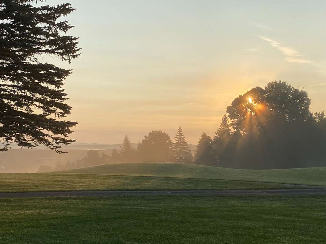 Golf cart on the cart path at sunset